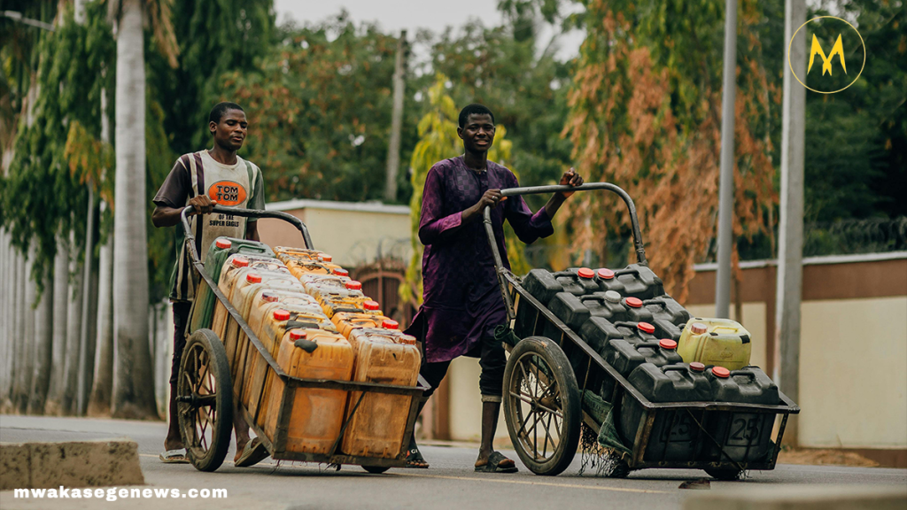 A rural African woman fetching clean water from a public tap in her village.