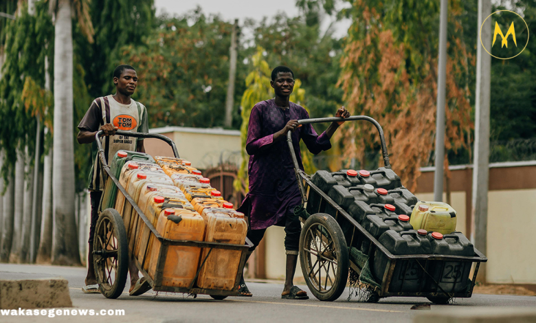 A rural African woman fetching clean water from a public tap in her village.