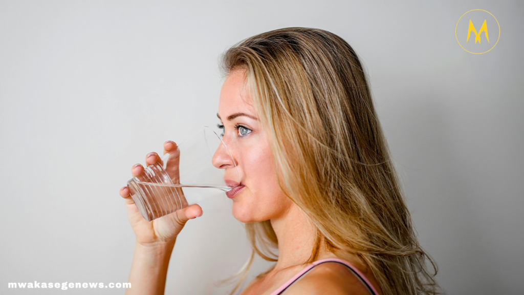 Woman drinking warm water in the morning for health benefits