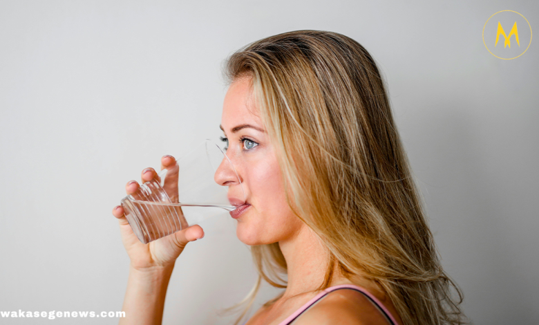 Woman drinking warm water in the morning for health benefits