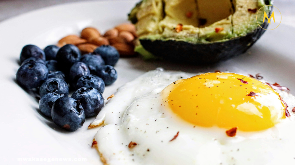 Healthy morning foods including eggs, berries, oats, and avocado toast on a breakfast table.