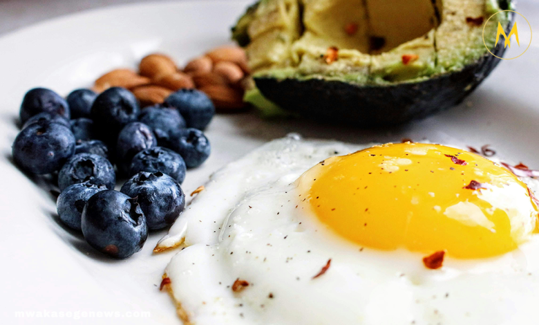 Healthy morning foods including eggs, berries, oats, and avocado toast on a breakfast table.