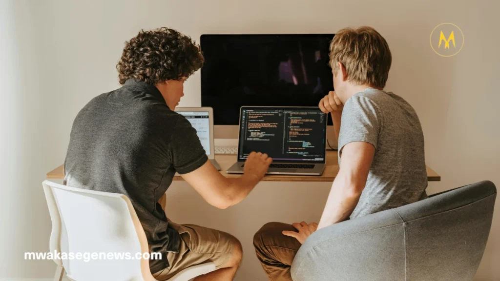 "A young African developer working on artificial intelligence software on a laptop"