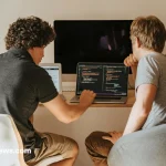 "A young African developer working on artificial intelligence software on a laptop"