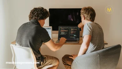 "A young African developer working on artificial intelligence software on a laptop"
