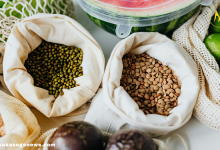 A flat lay of healthy superfoods like blueberries, spinach, yogurt, and salmon.