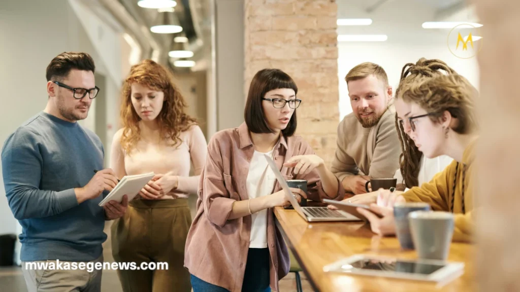New entrepreneurs discussing a startup plan around a laptop.