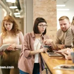 New entrepreneurs discussing a startup plan around a laptop.