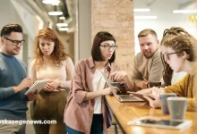 New entrepreneurs discussing a startup plan around a laptop.