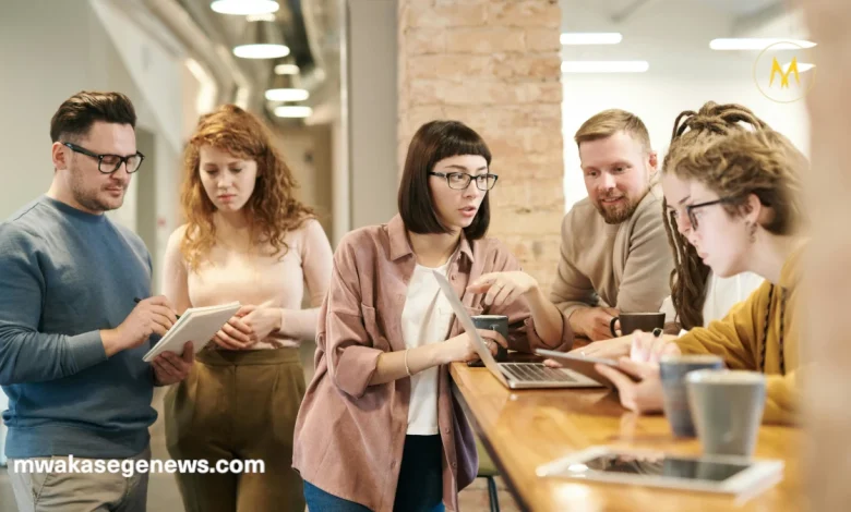 New entrepreneurs discussing a startup plan around a laptop.
