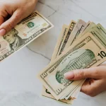 Woman calculating monthly savings at home