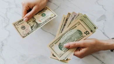 Woman calculating monthly savings at home