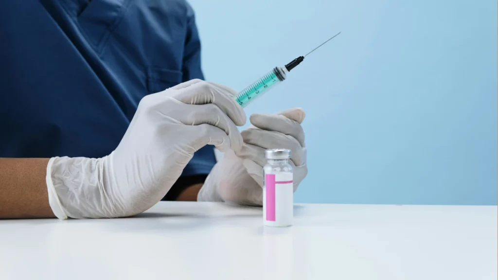 Typhoid vaccine vial and syringe on a medical table