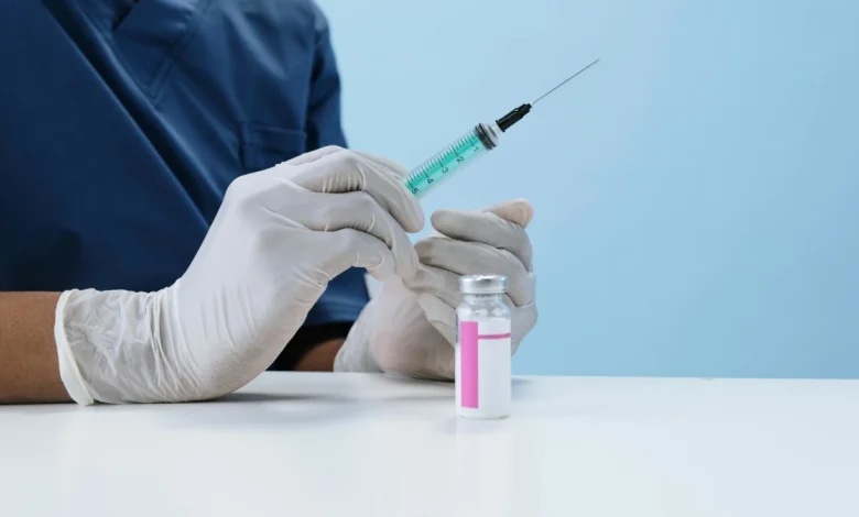 Typhoid vaccine vial and syringe on a medical table